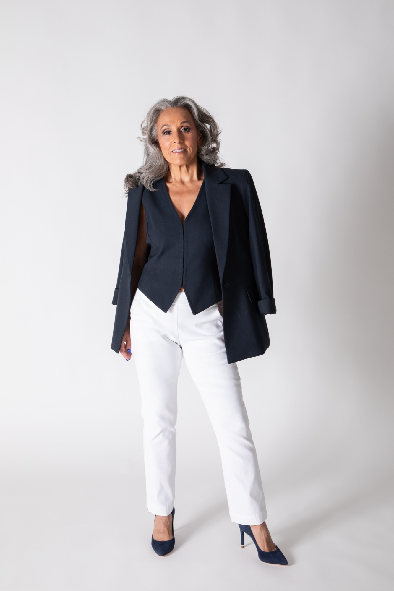 Nicole Jolie standing in the studio, jacket over her shoulders